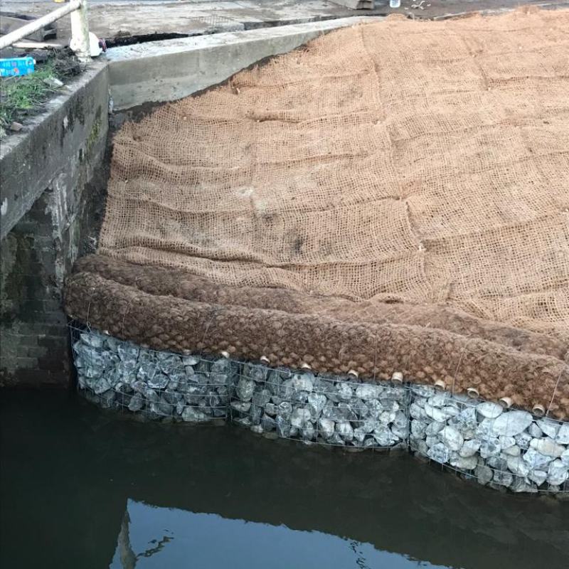 Gabon basket retaining wall, with coir mesh to prevent soil erosion prior to grass seed establishment.